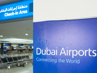 dubai airports sign "connecting the world" next to check in area