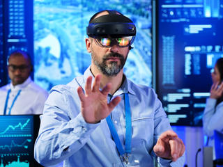 Command and control room operator using VR glasses