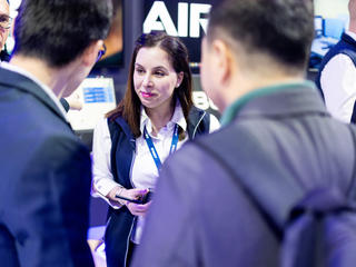 CCW 2025 Julie our business analyst discussing with visitors