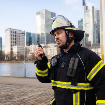 fireman_with_device_next_to_car_public_safety