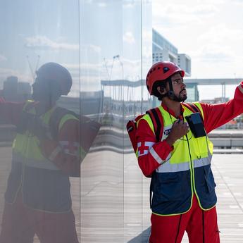 Paramedic man using PTT device and pointing his finger on top