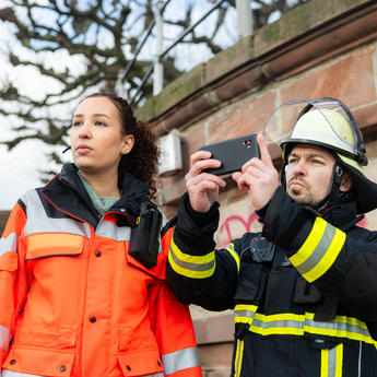 Fireman and a paramedic using an Agnet device