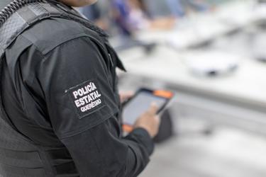 Close view on Querataro policeman holding a Tablet Close view on Querataro policeman holding a Tablet