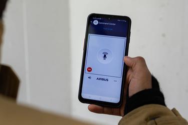 Close view on smartphone with Agnet push-to-talk user interface hold by professional user