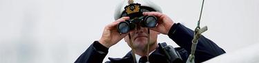 Coast guard with binoculars Coast guard with binoculars