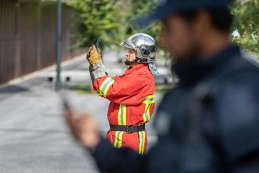 Fireman takes photo and police on the foreground