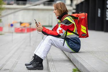 Paramedic at work uses a smartphone Paramedic at work uses a smartphone