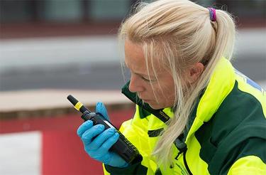Paramedic talking to TH9 TETRA radio Paramedic talking to TH9 TETRA radio