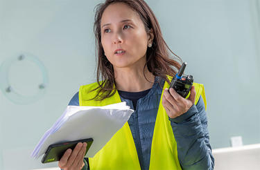 Airport worker with smartphone and radio Airport worker with smartphone and radio