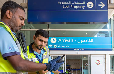 Dubai airport trolley staff with Dabat