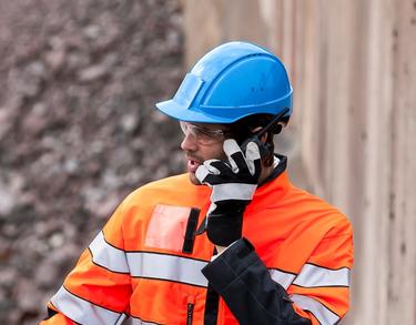 professional worker using TETRA radio in industrial plant professional worker using TETRA radio in industrial plant