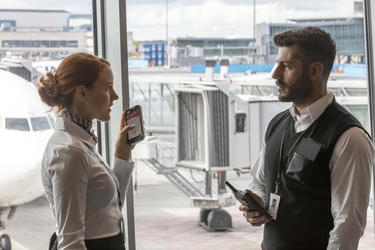 Airport staff having a conversation Airport staff having a conversation