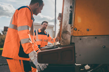 Garbage removal men working for a public utility