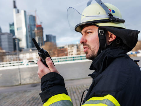 Fireman talking to a TH9 TETRA Terminal