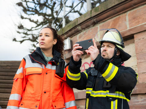 Fireman and a paramedic using an Agnet device