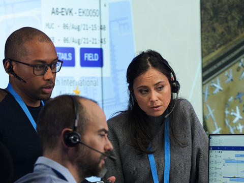 Command and control room operators discussing a case