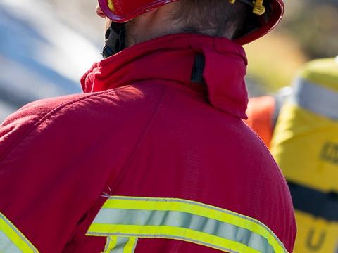 Fireman using THR880i TETRA radio