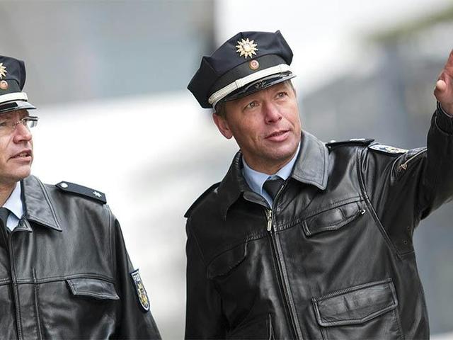 Two German police officers one pointing with finger