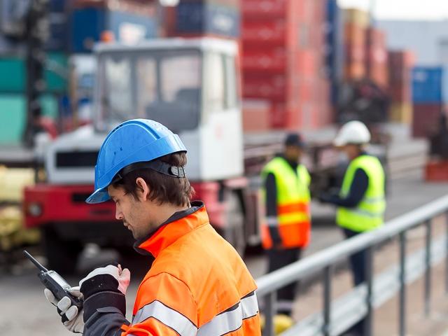 professional worker using TETRA radio in a port