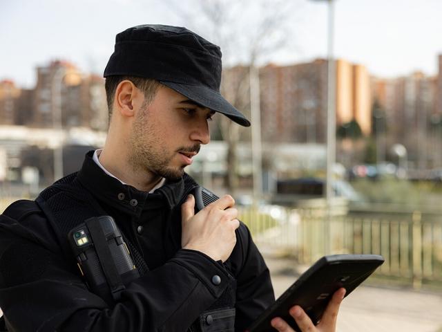 Security guard with tablet and push-to-talk