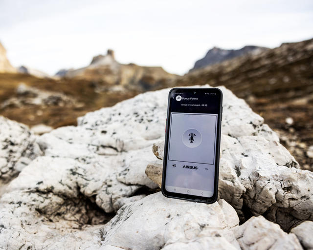 Agnet on a smartphone with a mountain view on the background Agnet on a smartphone with a mountain view on the background