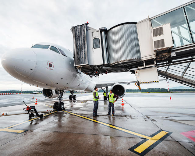 Ground handlers collaborating under a Airbus A320 during turnaround