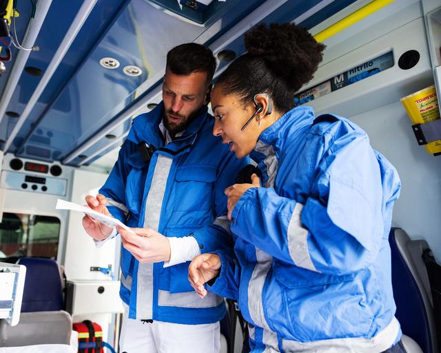 Paramedics doing a inventary inside a ambulance Paramedics doing a inventary inside a ambulance