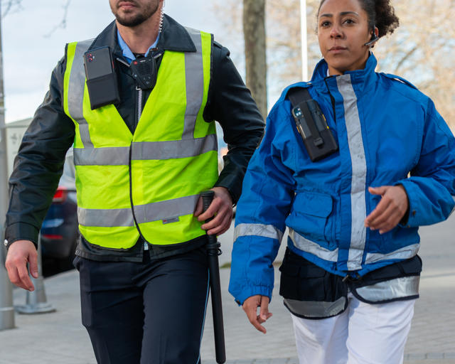 Paramedic and security guard walking