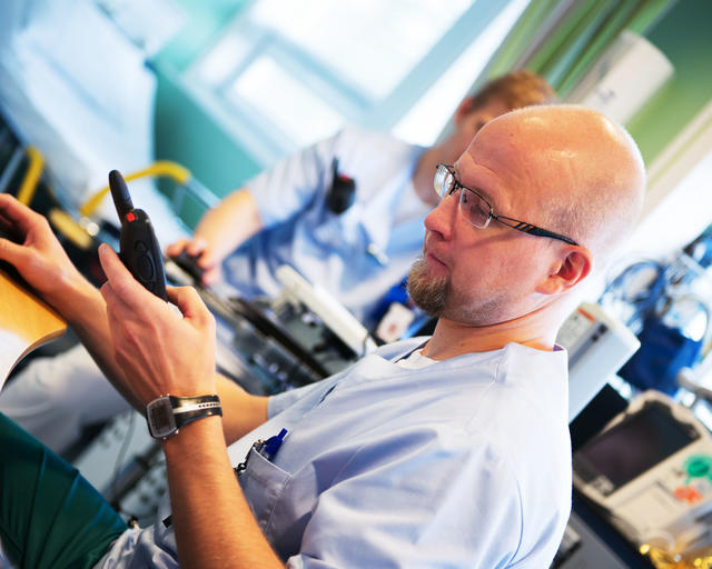 Paramedic communicating with his TMR880i Tetra terminal