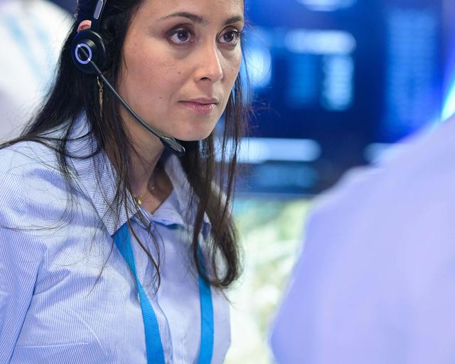 Control room operator discussing with a colleague