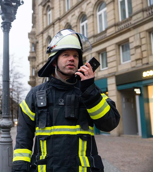 Fireman using agnet on the streets of Frankfurt