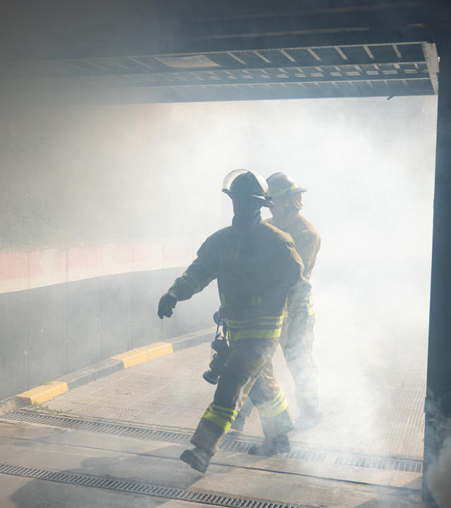 Public safety firefighters stepping into a building