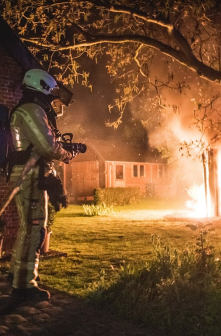 Firemen - 2 firemen fighting a forest fire at night