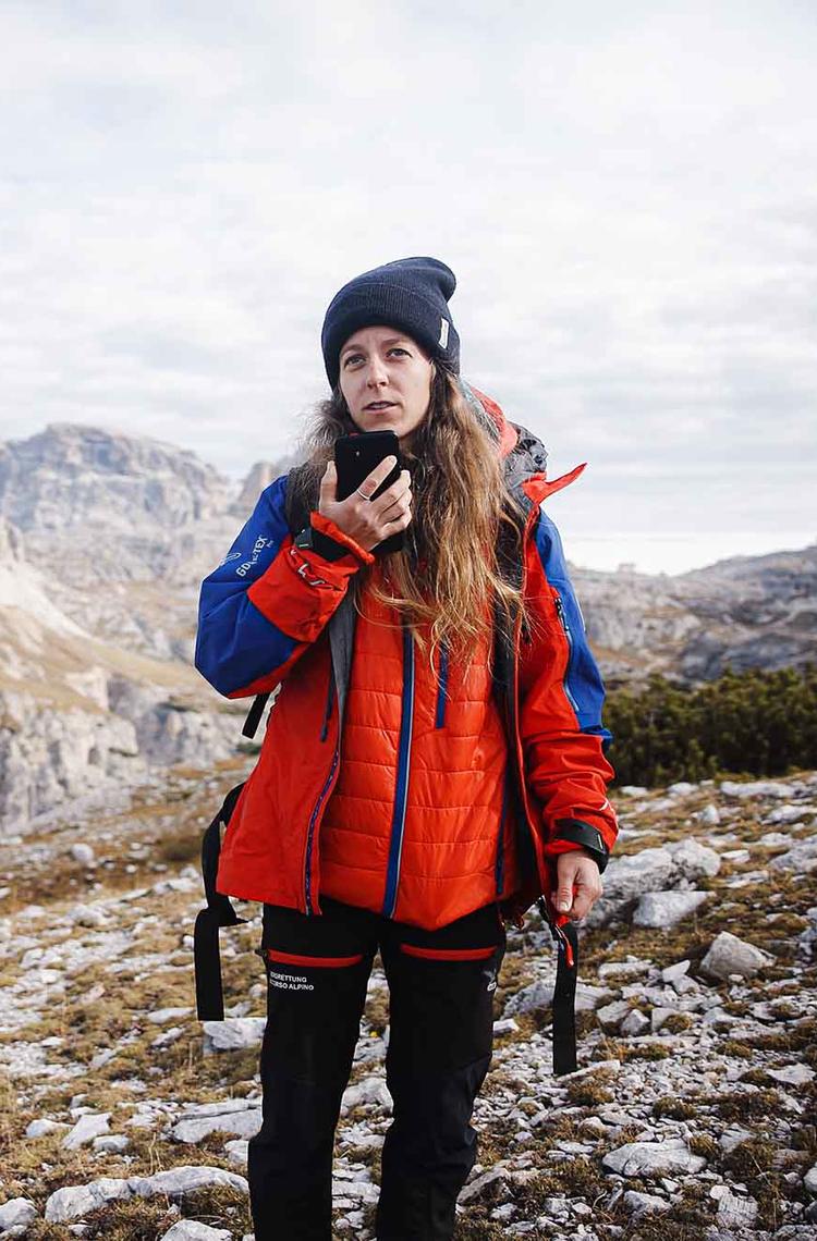 Hiker woman using Agnet over satcom with her smartphone in the mountains Hiker woman using Agnet over satcom with her smartphone in the mountains