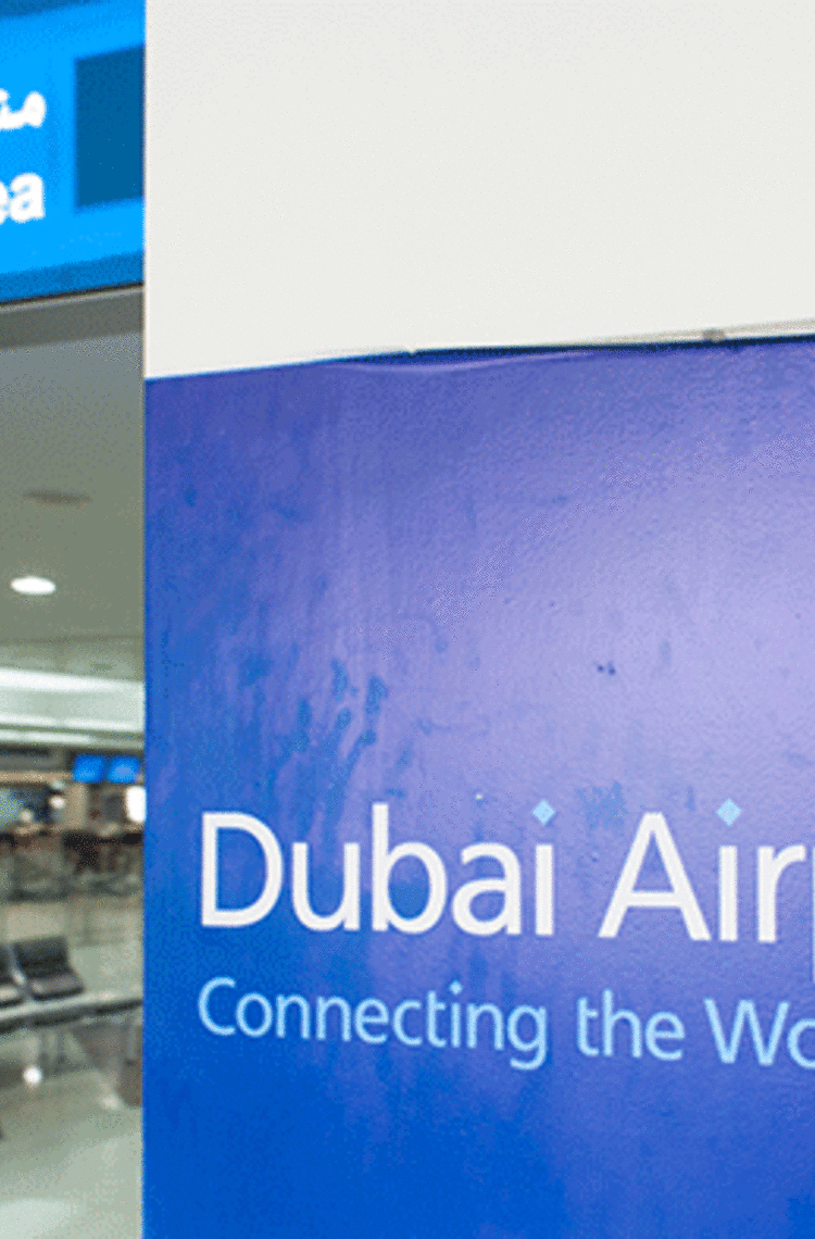 dubai airports sign "connecting the world" next to check in area dubai airports sign "connecting the world" next to check in area