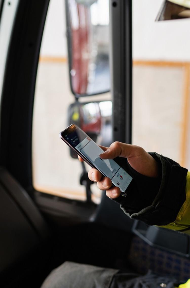 Fireman using Agnet PTT feature on his smartphone in his fire truck Fireman using Agnet PTT feature on his smartphone in his fire truck