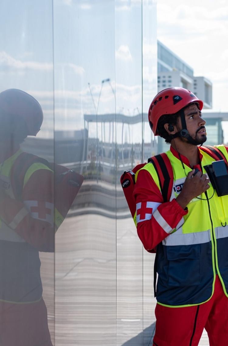 Paramedic man using PTT device and pointing his finger on top Paramedic man using PTT device and pointing his finger on top