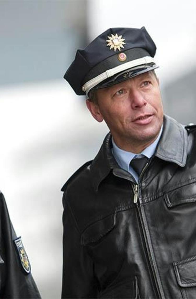 Two German police officers one pointing with finger Two German police officers one pointing with finger