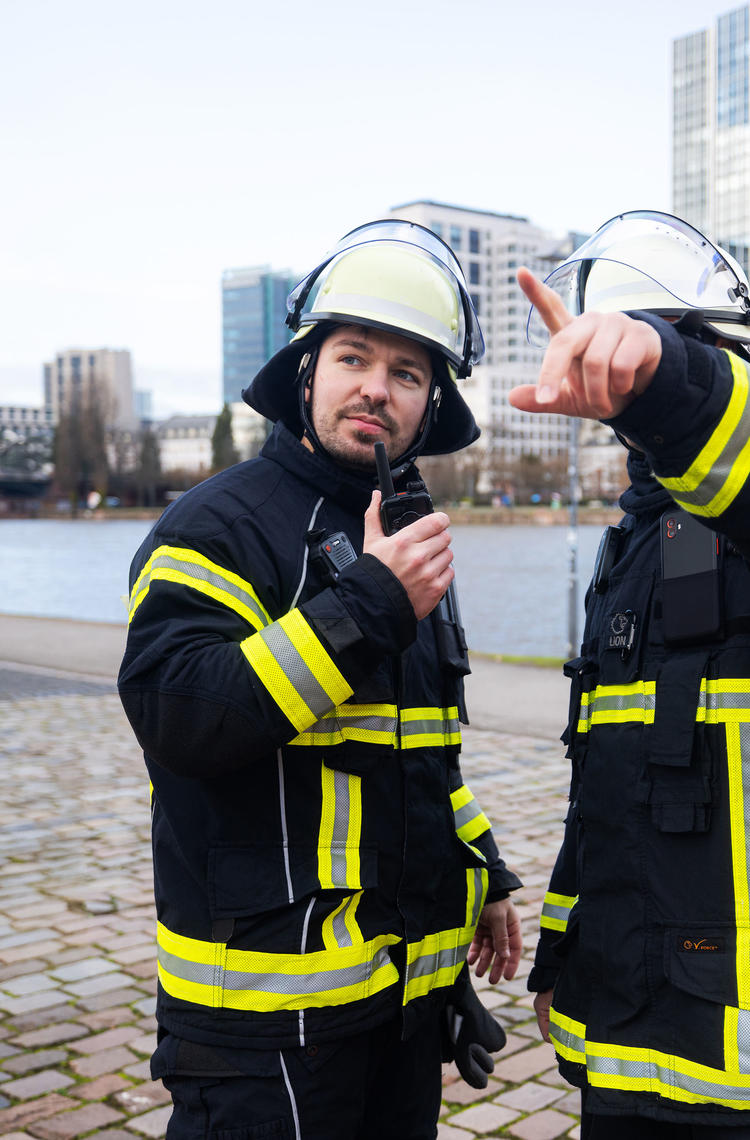 Firemen communicating with a Tetra terminal and Agnet on a smartdevice Firemen communicating with a Tetra terminal and Agnet on a smartdevice