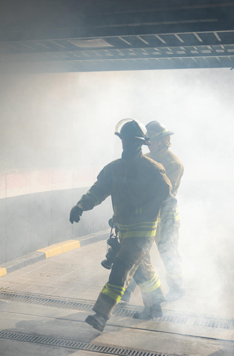 Public safety firefighters stepping into a building Public safety firefighters stepping into a building