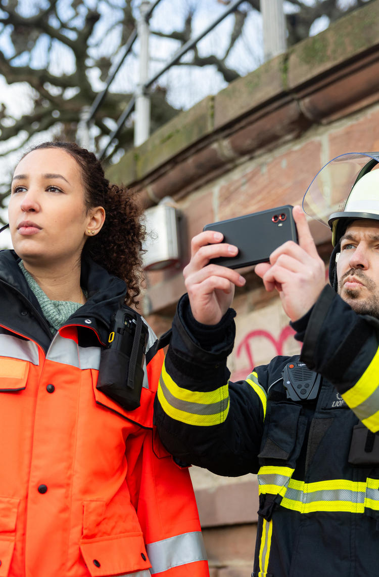 Fireman and a paramedic using an Agnet device