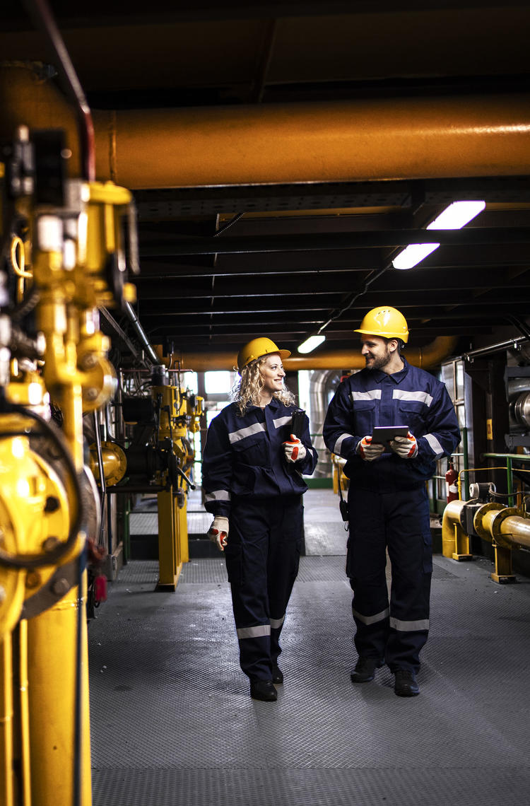 Industry workers checking the pipes for leaks and informing about the situation with Agnet Industry workers checking the pipes for leaks and informing about the situation with Agnet