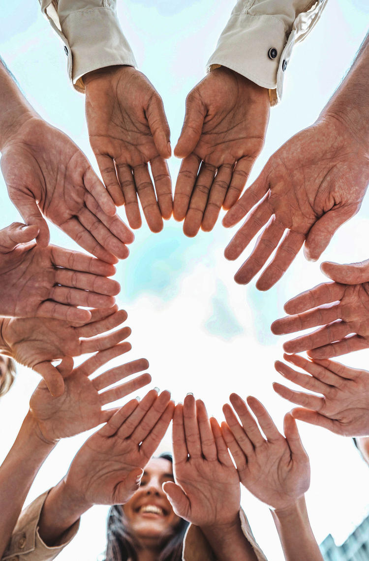 People stacking hands together