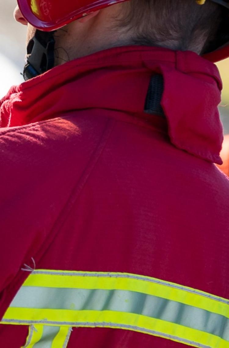 Fireman using THR880i TETRA radio