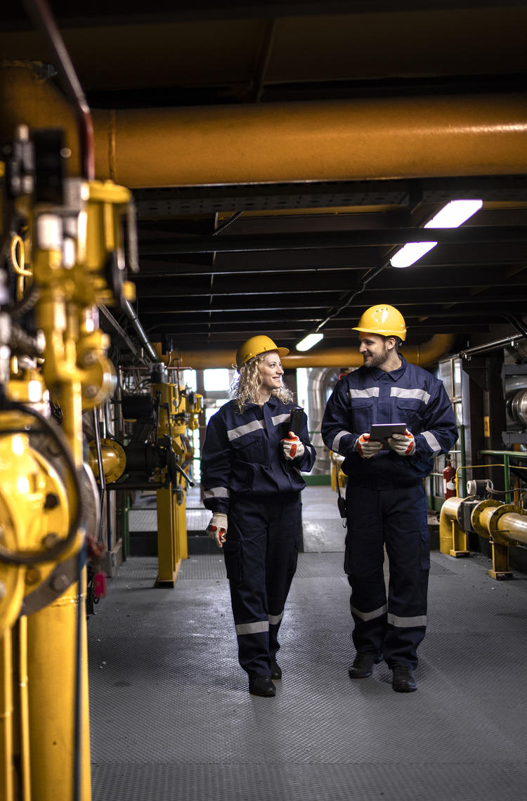 two workers investigating if everything is ok at a gas powerplant two workers investigating if everything is ok at a gas powerplant