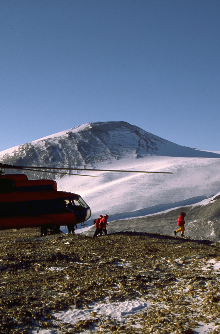 Helicopter landing on a mountain valley Helicopter landing on a mountain valley