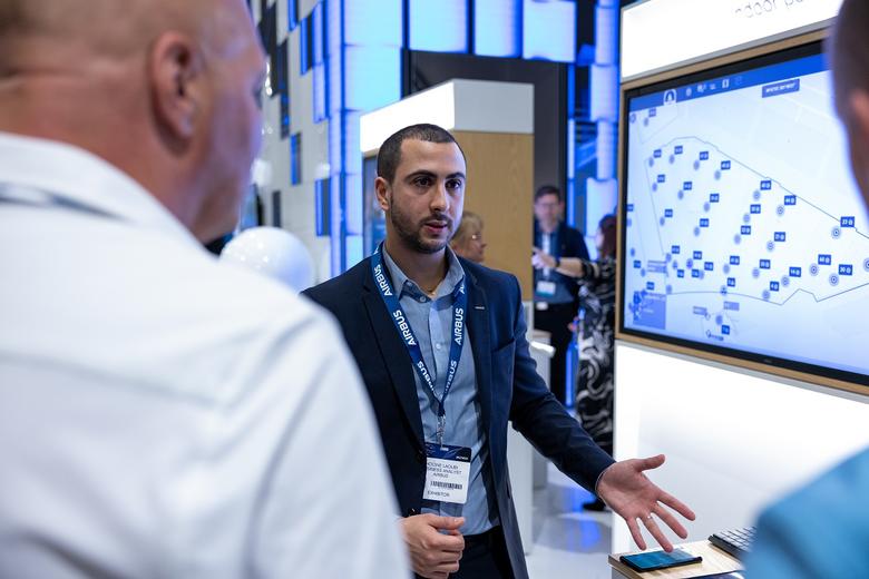 CCW 2023 - Airbus Business Analyst demonstrating Agnet Dispatcher on a screen to two visitors
