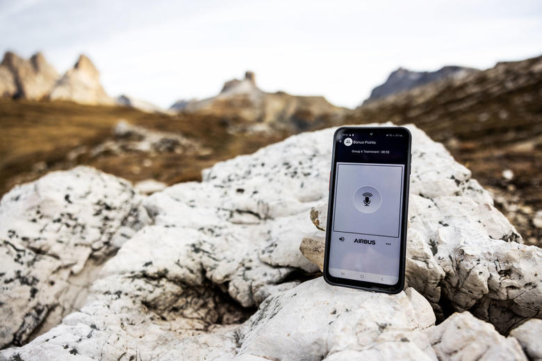 Agnet on a smartphone with a mountain view on the background