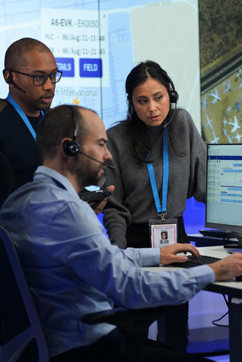 Command and control room operators discussing a case